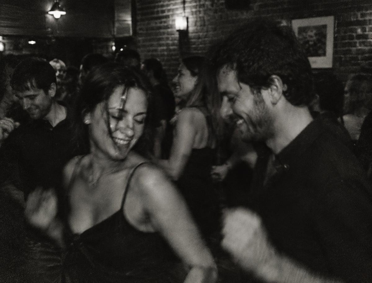 People dancing together in a small club